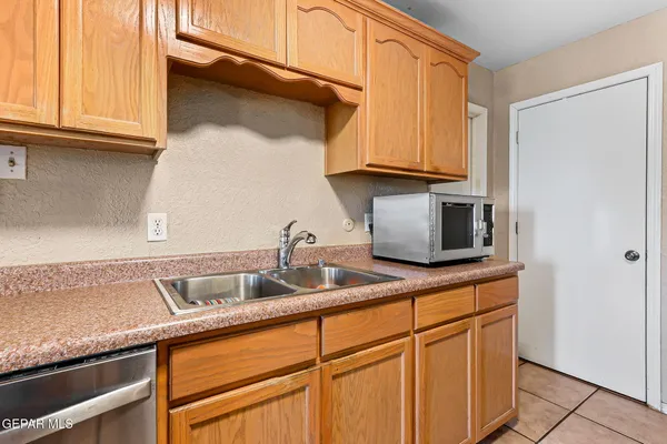 a kitchen with granite countertop a sink and cabinets