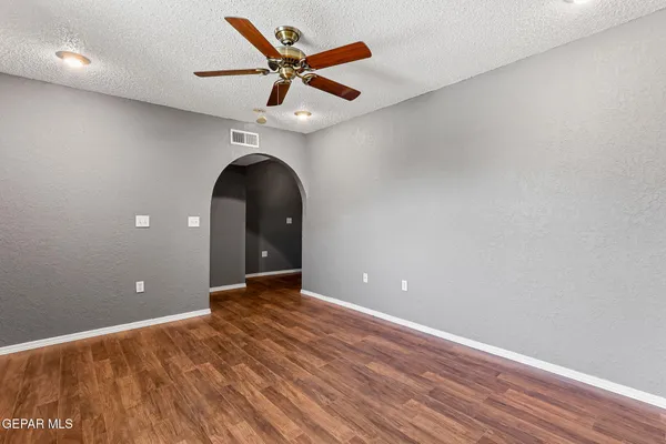 a view of empty room with wooden floor