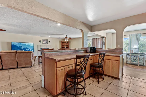 a kitchen with stainless steel appliances kitchen island granite countertop a stove a sink and a refrigerator