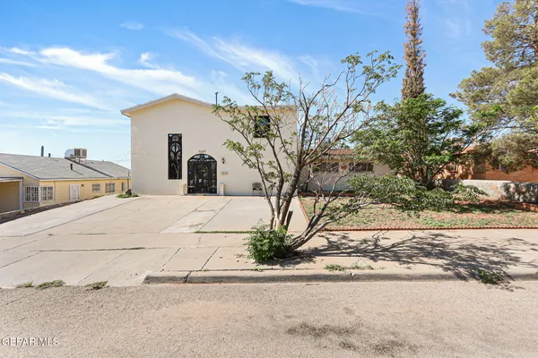 a view of a white house with a street