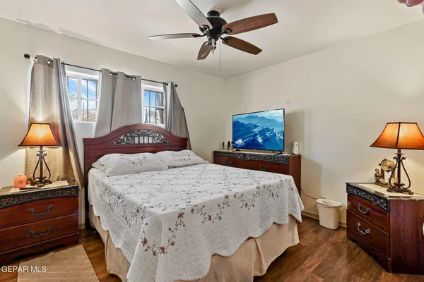 a bedroom with a bed and a chandelier