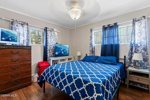 a bedroom with a bed and dresser with mirror