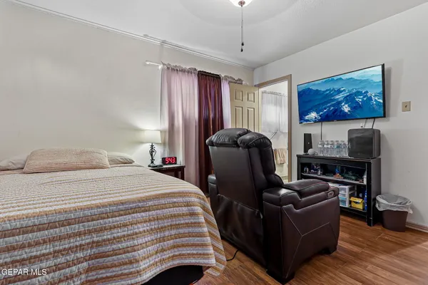 a bedroom with furniture and wooden floor