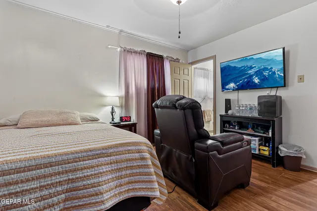 a bedroom with furniture and wooden floor