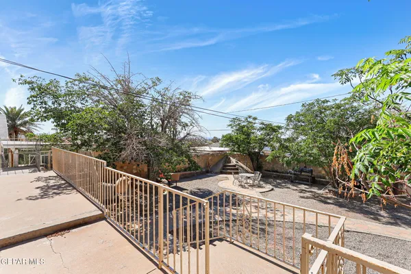 a view of a balcony with wooden fence