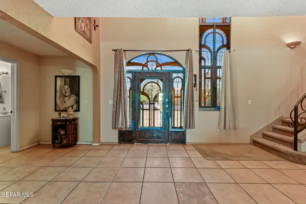 a view of entryway and hall with a mirror