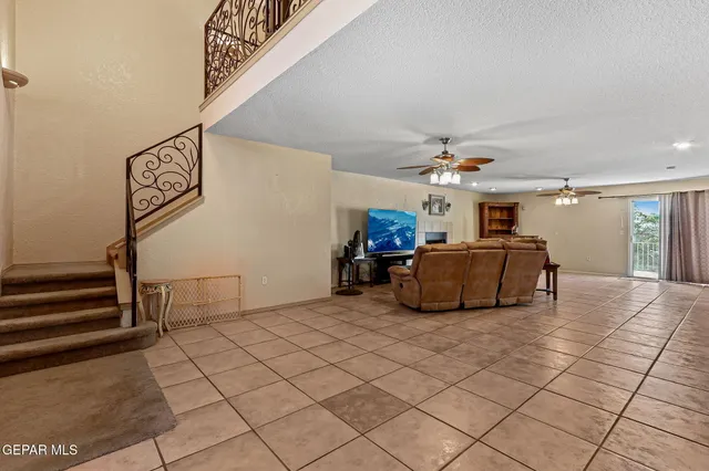 a view of a livingroom with furniture and a ceiling fan