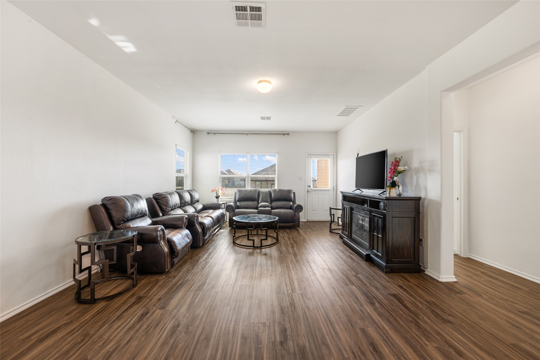 132 Joe Kidd Lane Jarrell, TX 76537 - Photo 11 of 39 a living room with furniture and a flat screen tv