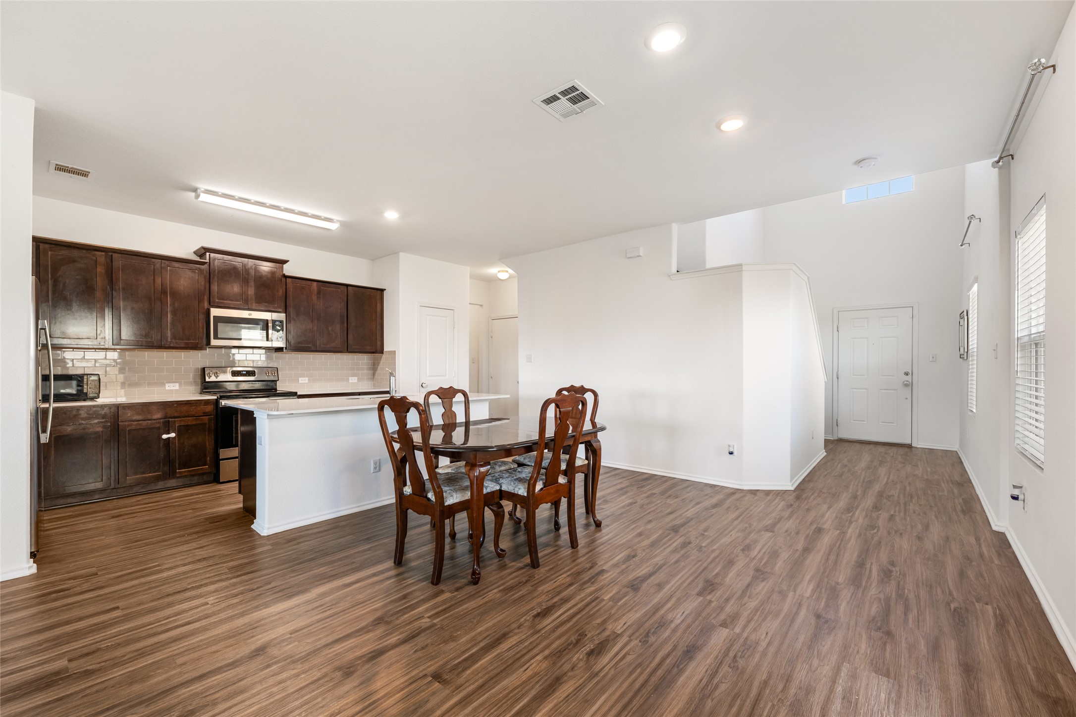 132 Joe Kidd Lane Jarrell, TX 76537 - Photo 13 of 39 a view of a dining room with furniture and wooden floor