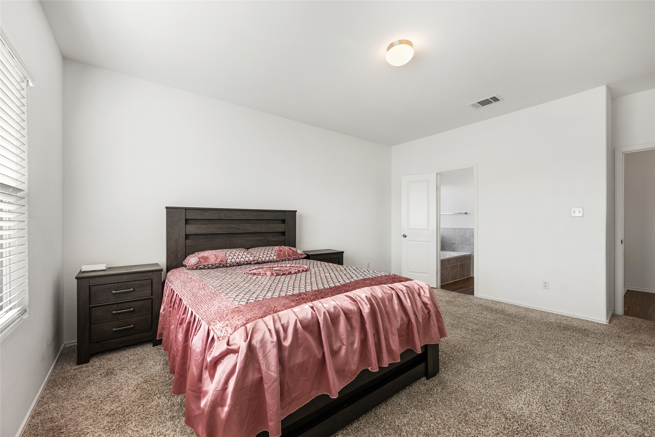 132 Joe Kidd Lane Jarrell, TX 76537 - Photo 16 of 39 a bedroom with a bed and a tv