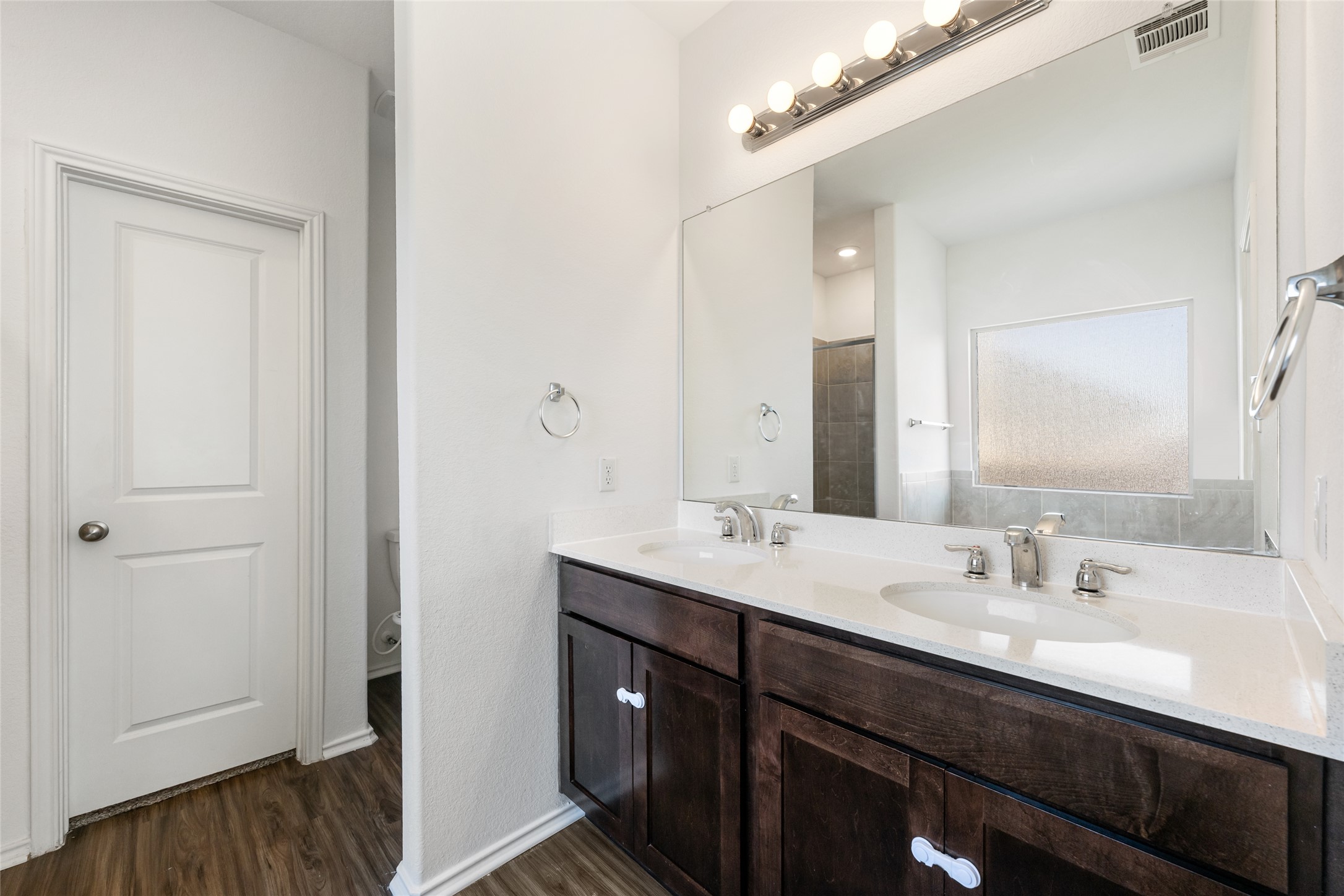 132 Joe Kidd Lane Jarrell, TX 76537 - Photo 17 of 39 a bathroom with a double vanity sink and mirror