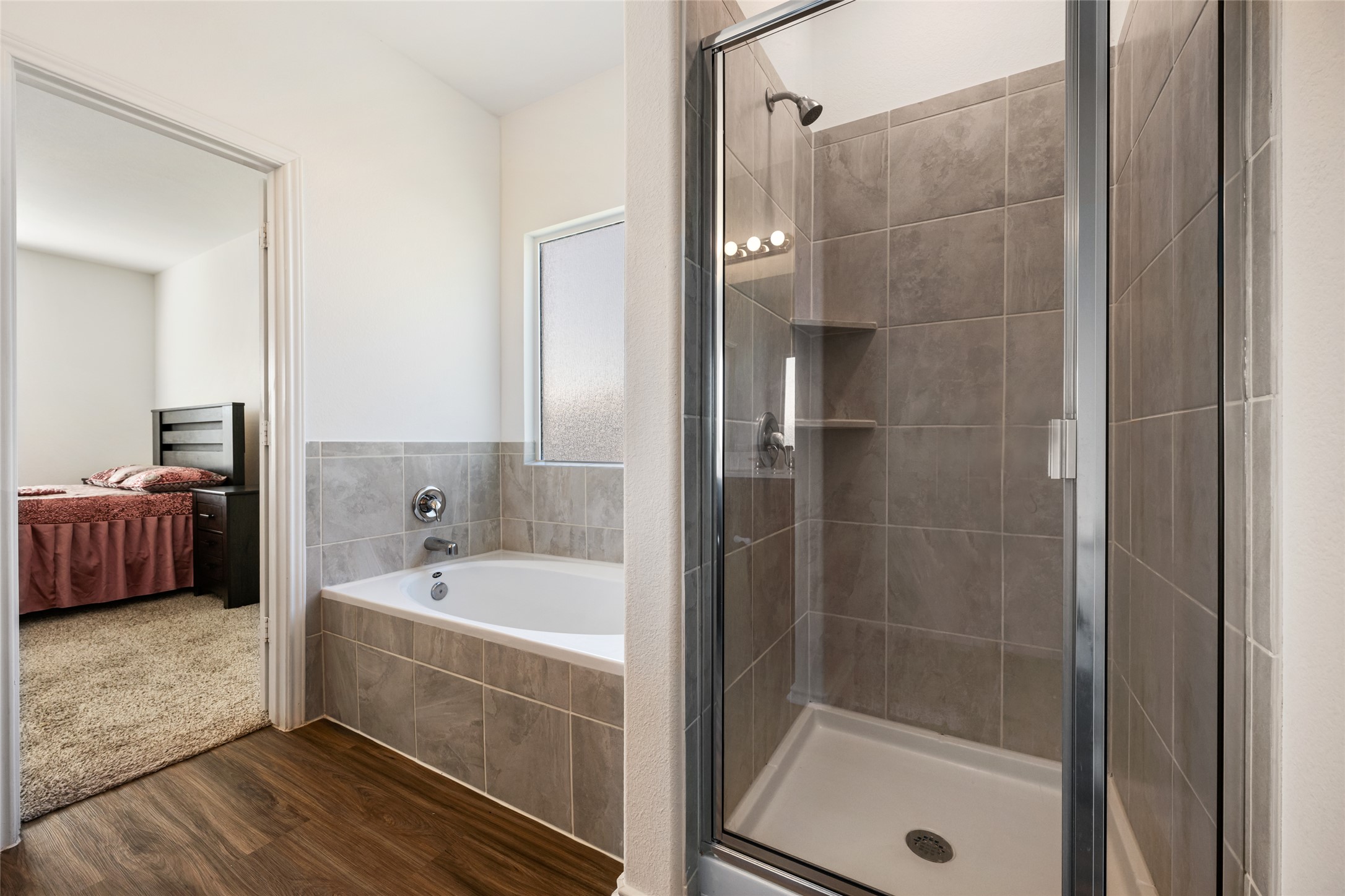 132 Joe Kidd Lane Jarrell, TX 76537 - Photo 20 of 39 a bathroom with a tub a sink and a large mirror