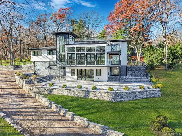 a front view of a house with a yard table and chairs