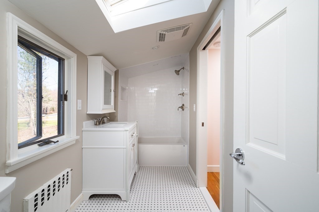 4 King Philip Path Hingham, MA 02043 - Photo 12 of 21 a bathroom with a sink a toilet and a window