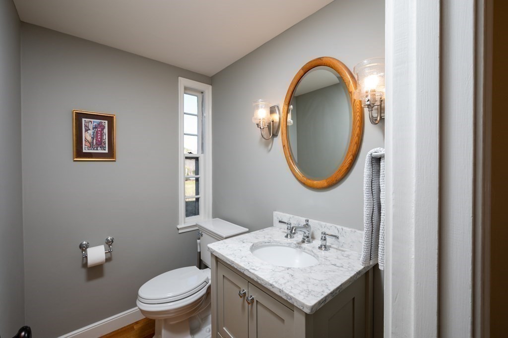 4 King Philip Path Hingham, MA 02043 - Photo 14 of 21 a bathroom with a toilet sink and mirror