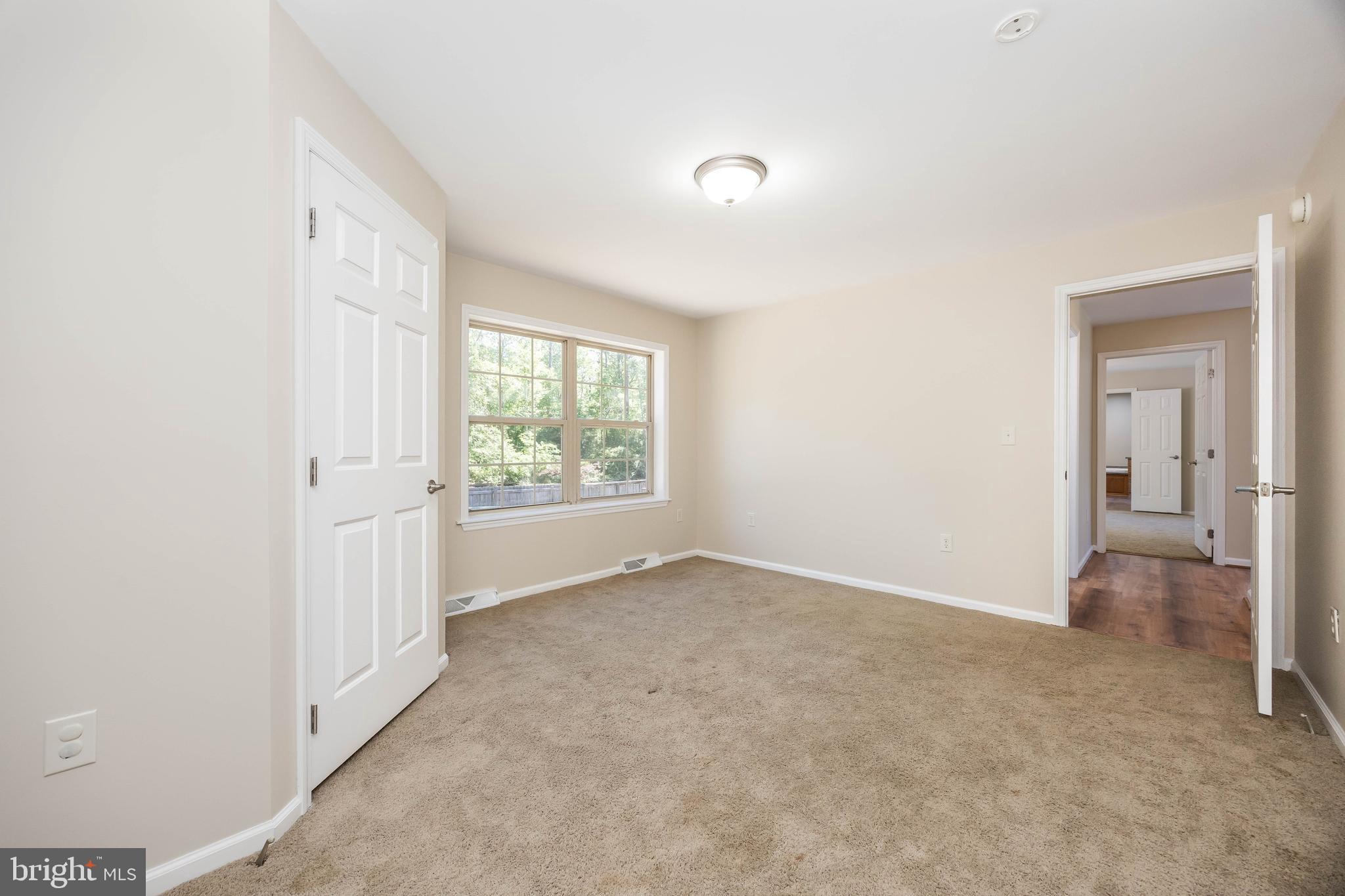 6635 Libertytown Road Berlin, MD 21811 - Photo 39 of 88 an empty room with a window and a bathroom