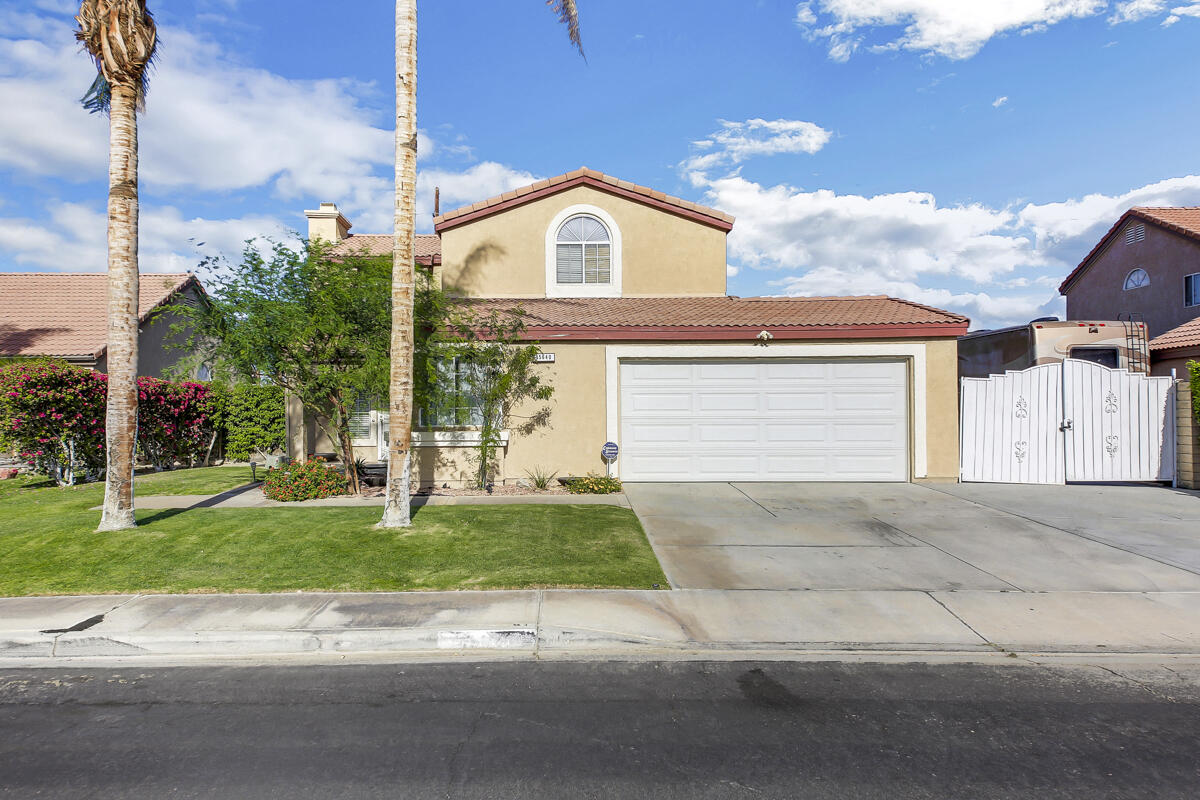 45640 Cimarron Road Indio, CA 92201 - Photo 1 of 25 a view of a house with a yard and large parking space
