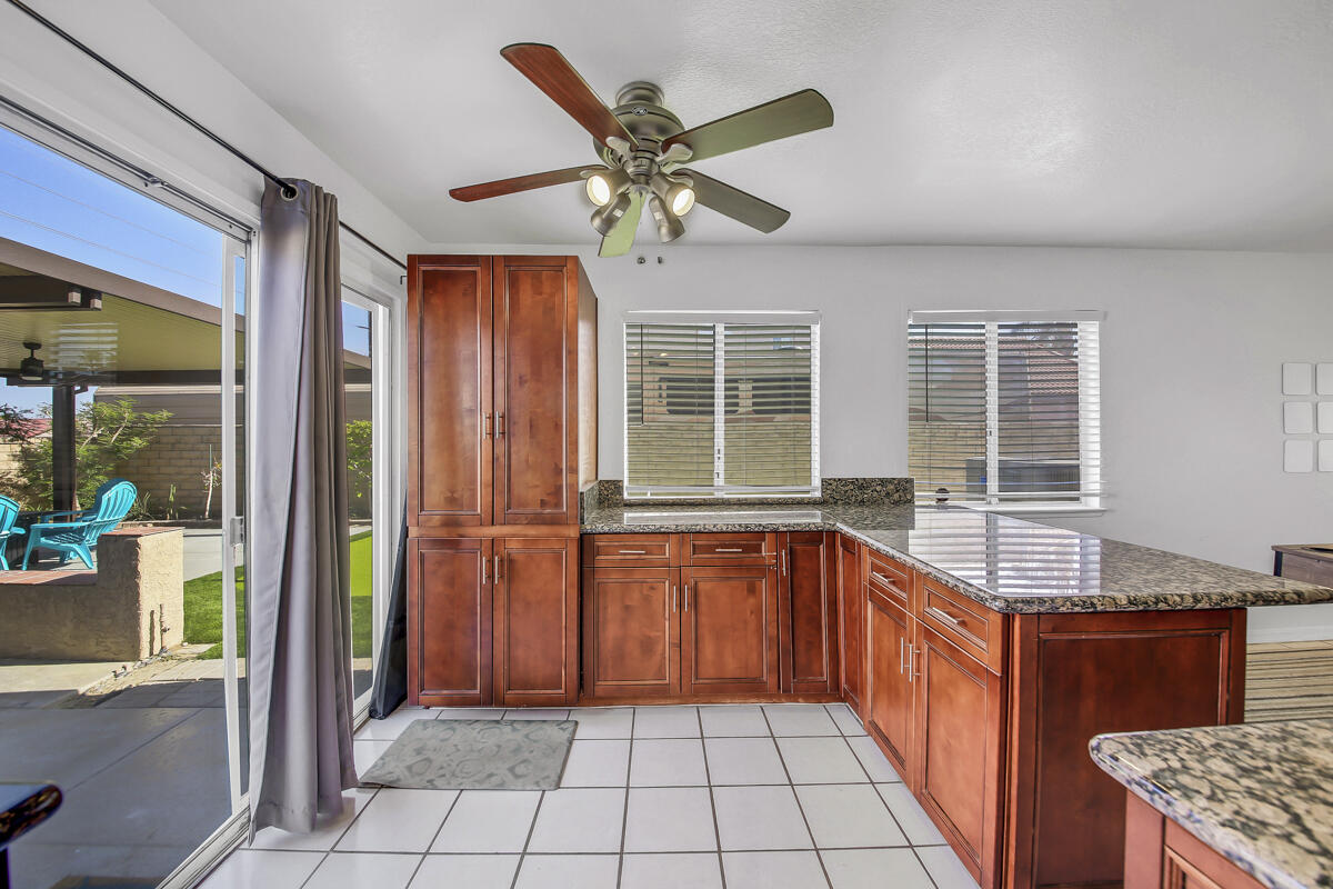 45640 Cimarron Road Indio, CA 92201 - Photo 11 of 25 a kitchen with stainless steel appliances granite countertop a refrigerator a sink and dishwasher