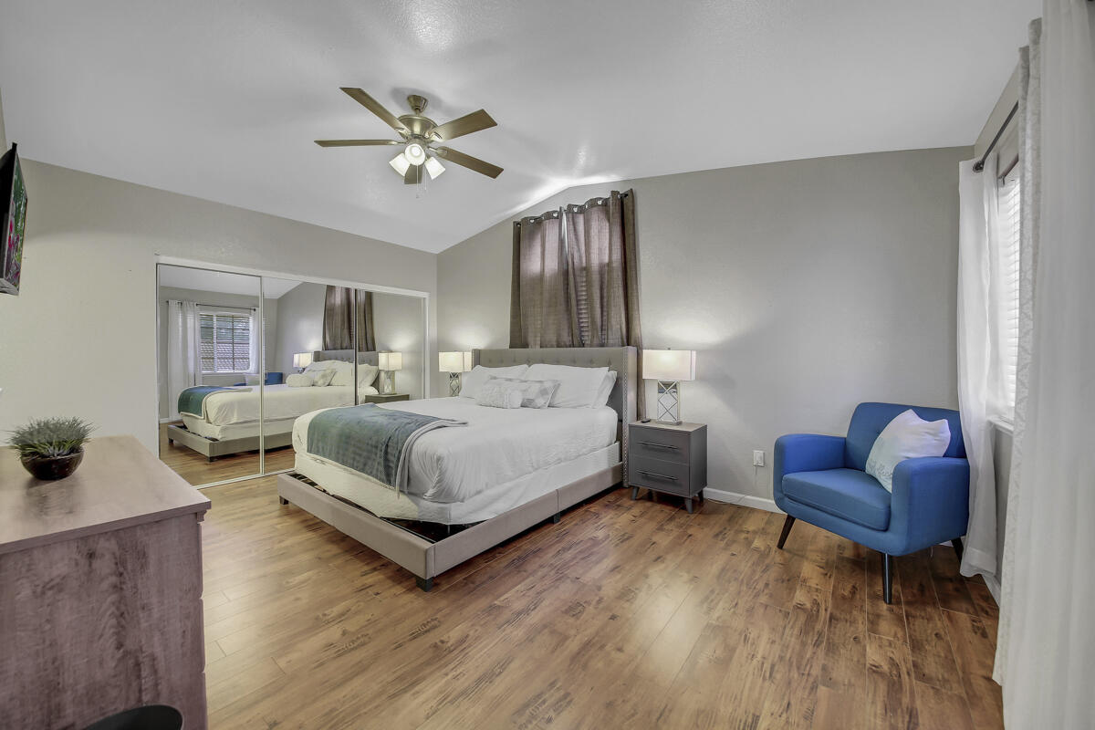 45640 Cimarron Road Indio, CA 92201 - Photo 17 of 25 a bedroom with a bed couches and a dresser with wooden floor