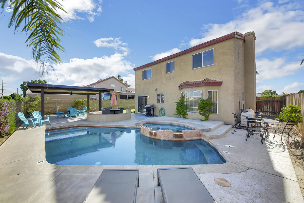 45640 Cimarron Road Indio, CA 92201 - Photo 2 of 25 a view of a patio with swimming pool table and chairs