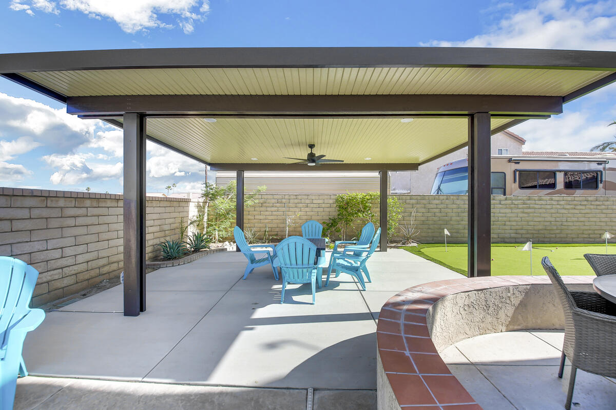 45640 Cimarron Road Indio, CA 92201 - Photo 22 of 25 a view of a patio with table and chairs potted plants with floor to ceiling window