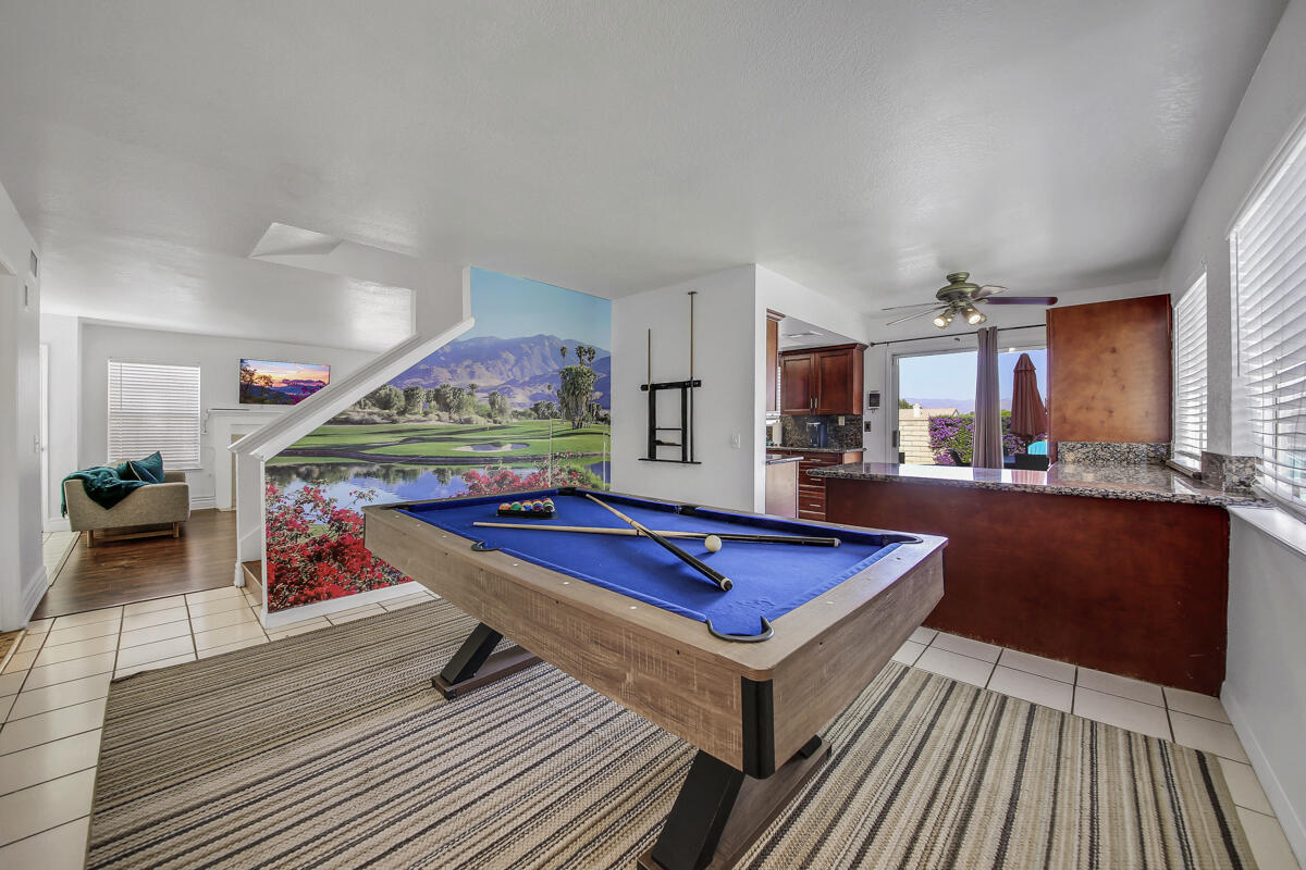 45640 Cimarron Road Indio, CA 92201 - Photo 8 of 25 a living room with furniture a table and kitchen view