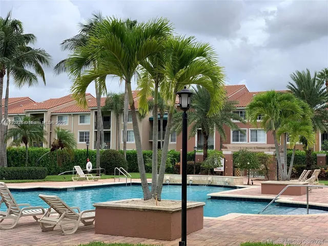 a view of a house with swimming pool and sitting area