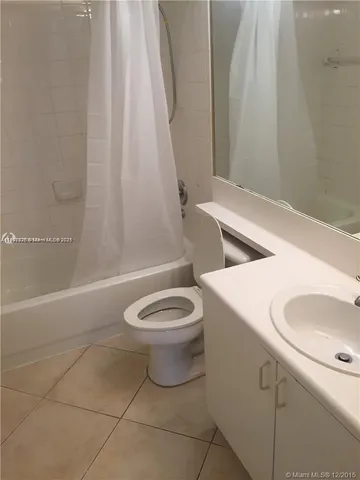 a bathroom with a toilet sink and shower