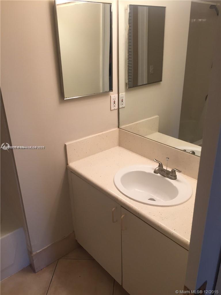 7816 Sonoma Springs Circle, Unit 104 Lake Worth, FL 33463 - Photo 4 of 12 a bathroom with a sink and a mirror