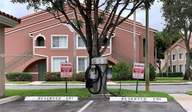 a front view of a house with a garden and plants
