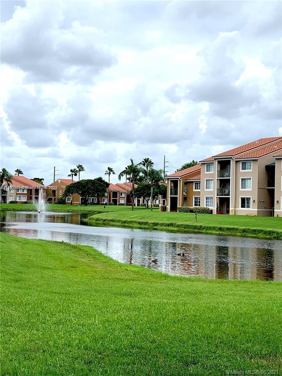 7816 Sonoma Springs Circle, Unit 104 Lake Worth, FL 33463 - Photo 10 of 12 a front view of a house with a yard