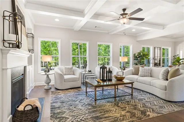 a view of a dining room and livingroom with furniture wooden floor a chandelier