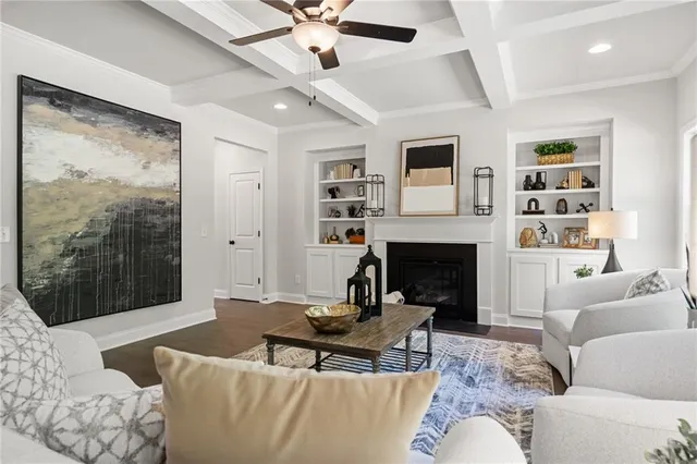 a kitchen with white cabinets and clock on the wall