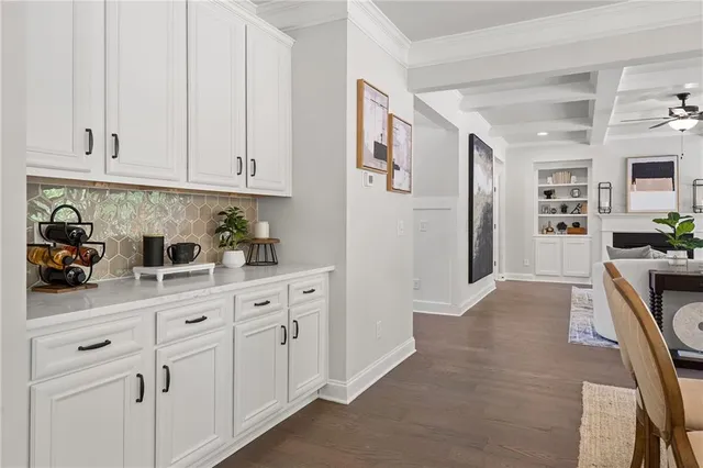 a kitchen with granite countertop a sink and a stove top oven