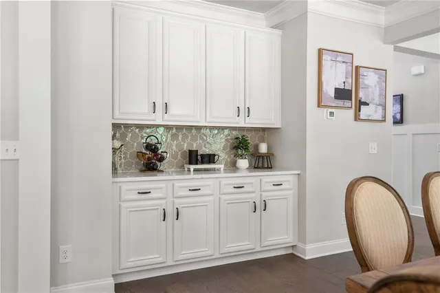 a kitchen with white cabinets appliances and a sink