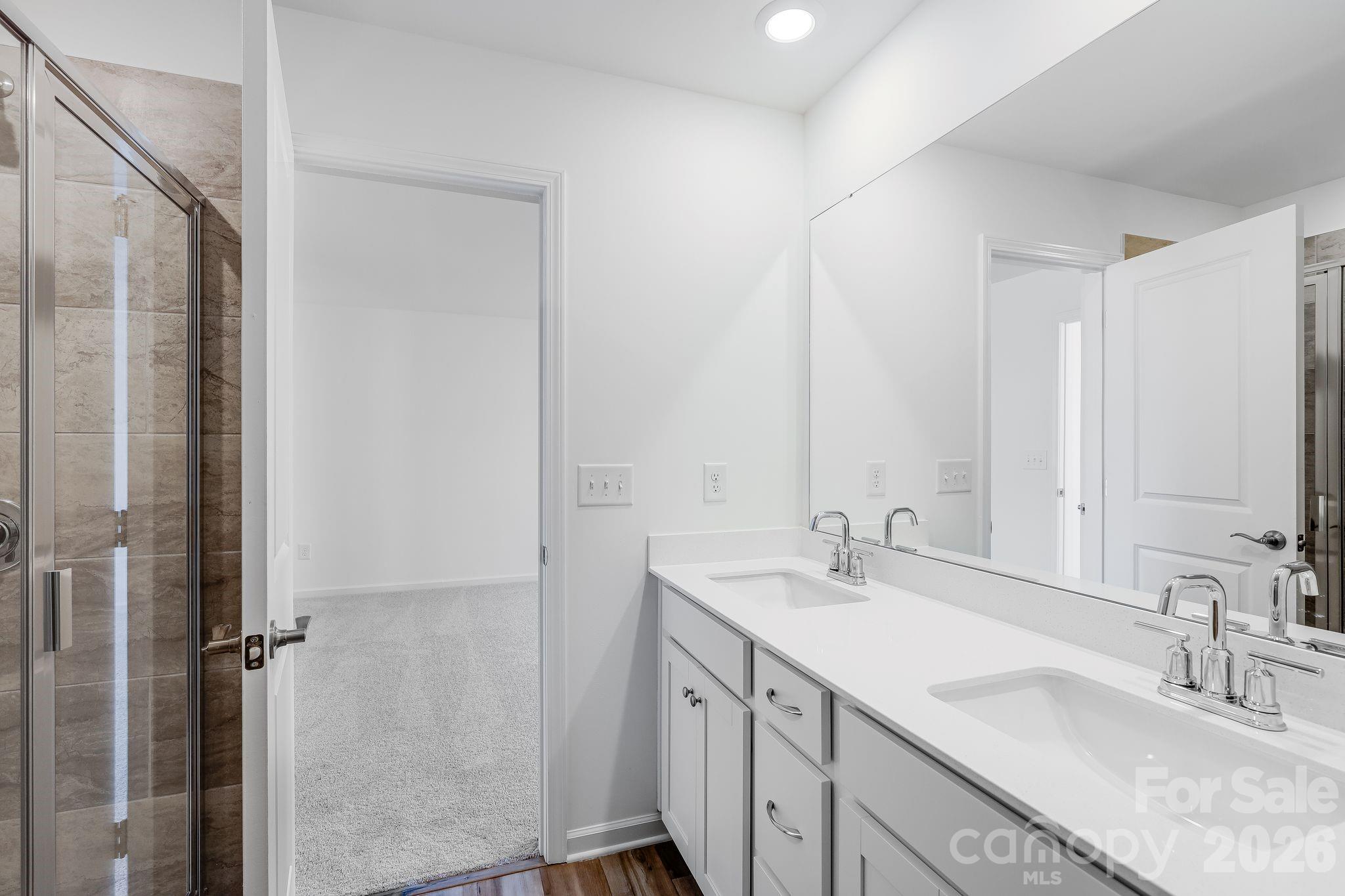 631 Sparano Loop York, SC 29745 - Photo 13 of 15 a bathroom with double vanity sinks and a mirror