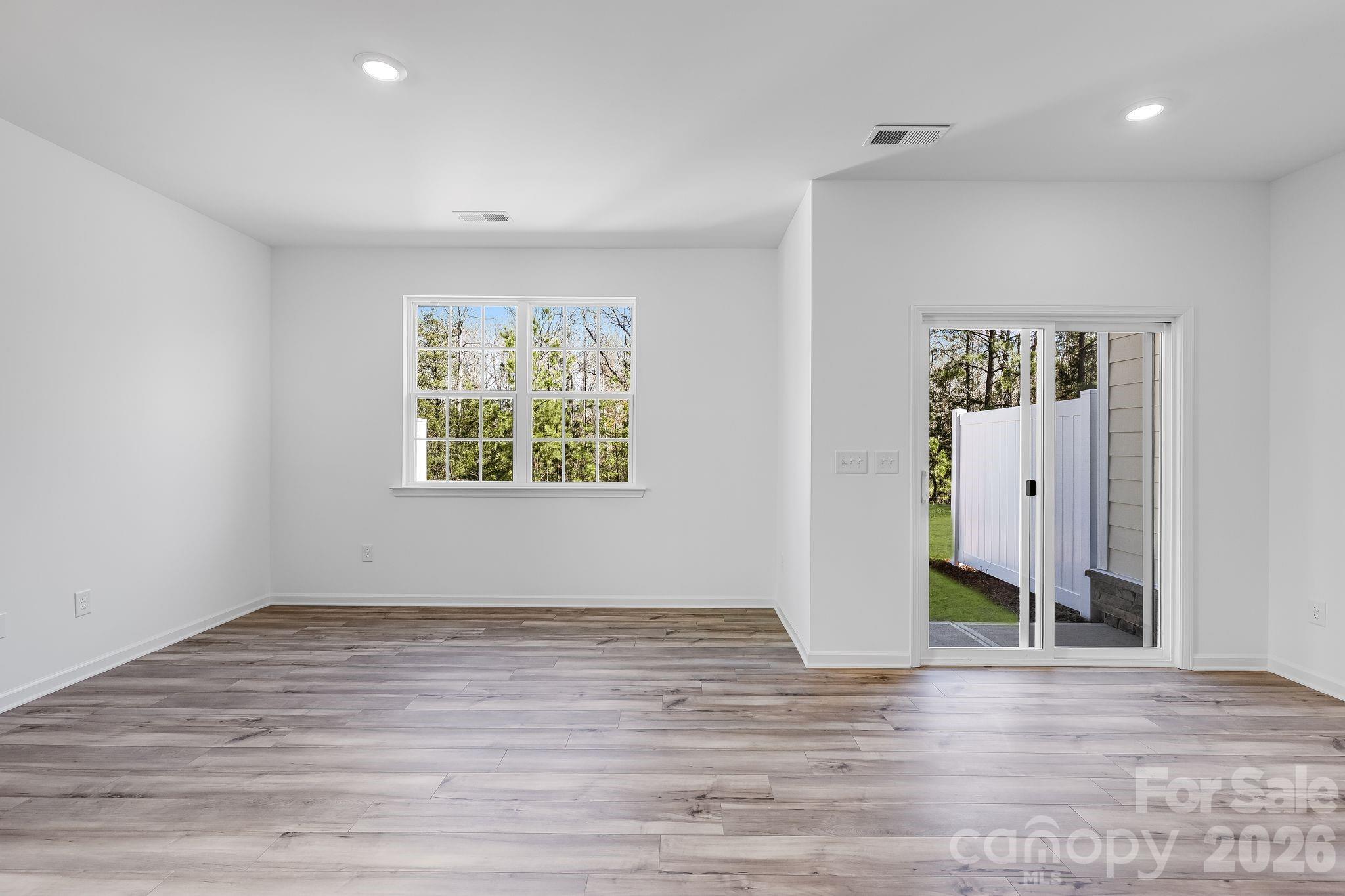 631 Sparano Loop York, SC 29745 - Photo 7 of 15 an empty room with wooden floor and window