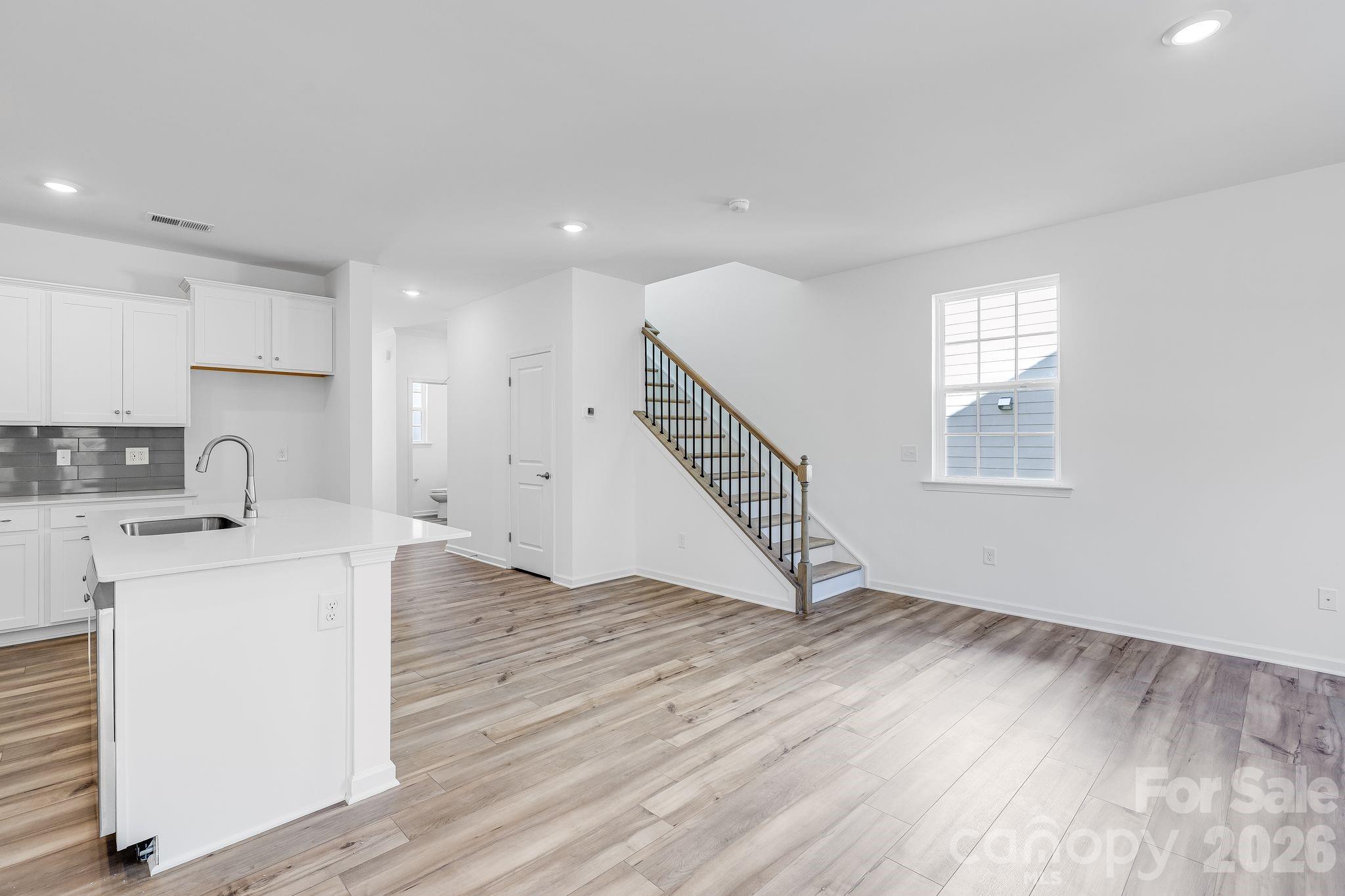 631 Sparano Loop York, SC 29745 - Photo 8 of 15 a view of a kitchen with a sink wooden floor and staircase