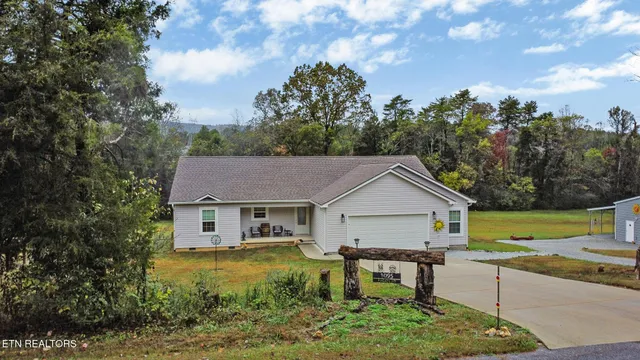 a view of house with backyard and garden