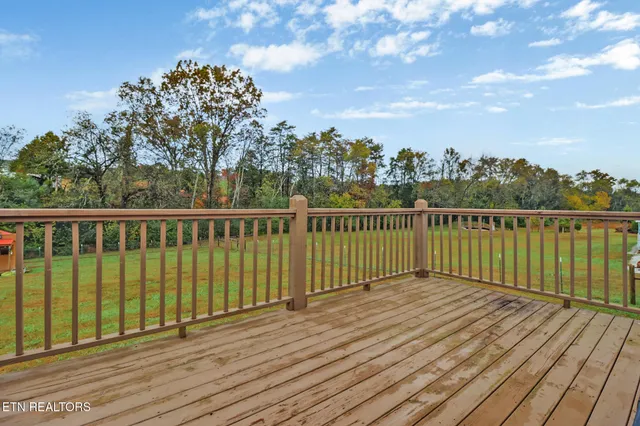 a view of a balcony with wooden floor and city view