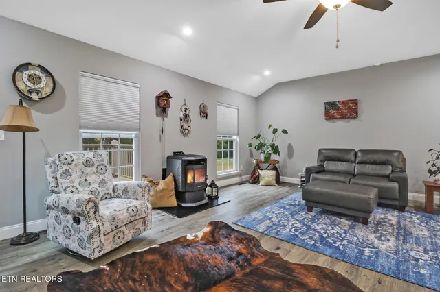 a living room with furniture a fireplace and a chandelier