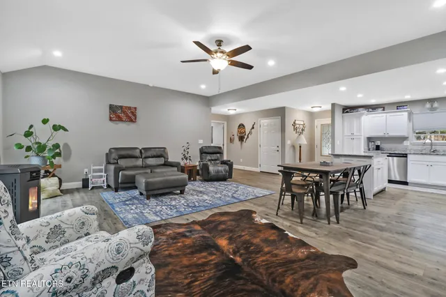 a living room with furniture kitchen view and a dining table