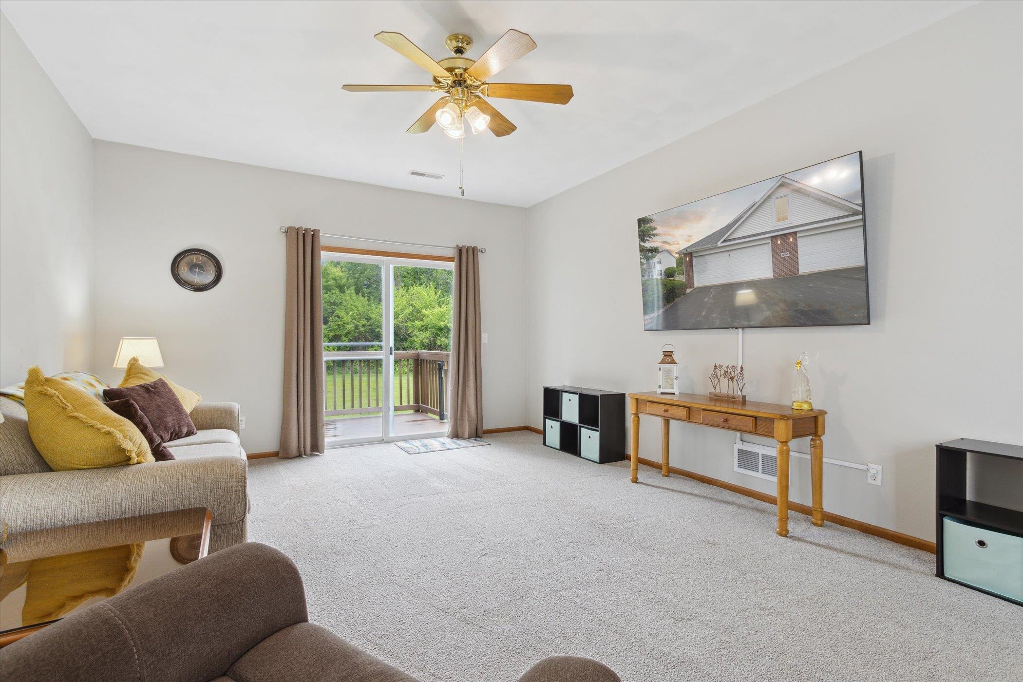 10156 Metalmark Lane, Unit 2 Roscoe, IL 61073 - Photo 12 of 38 a living room with furniture and a flat screen tv