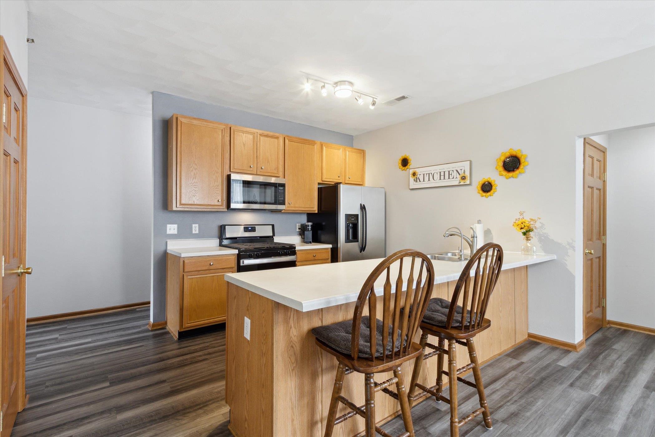 10156 Metalmark Lane, Unit 2 Roscoe, IL 61073 - Photo 15 of 38 a view of kitchen with furniture and wooden floor