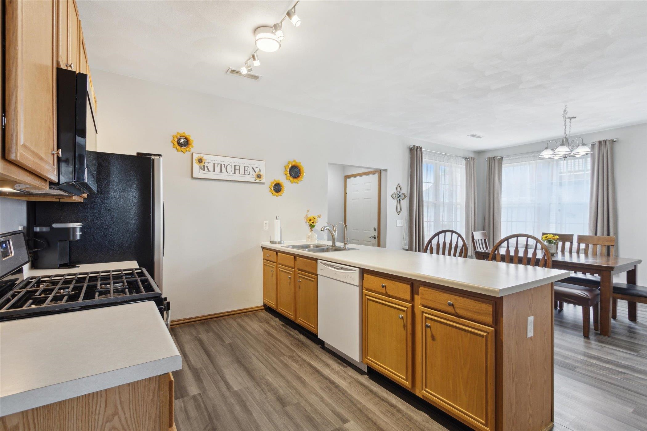 10156 Metalmark Lane, Unit 2 Roscoe, IL 61073 - Photo 17 of 38 a kitchen with granite countertop a sink a counter space appliances and cabinets