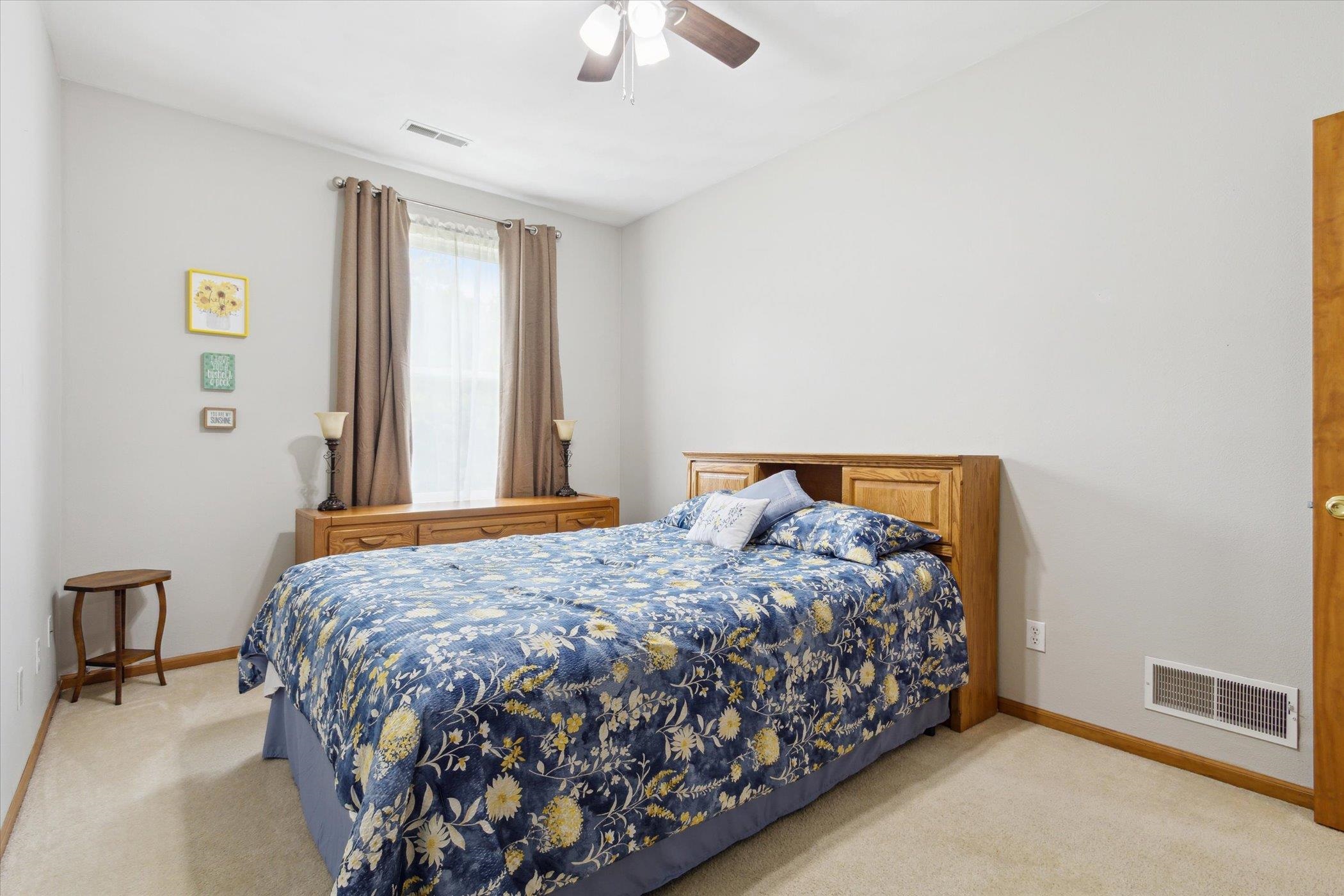 10156 Metalmark Lane, Unit 2 Roscoe, IL 61073 - Photo 23 of 38 a bedroom with a bed and a lamp