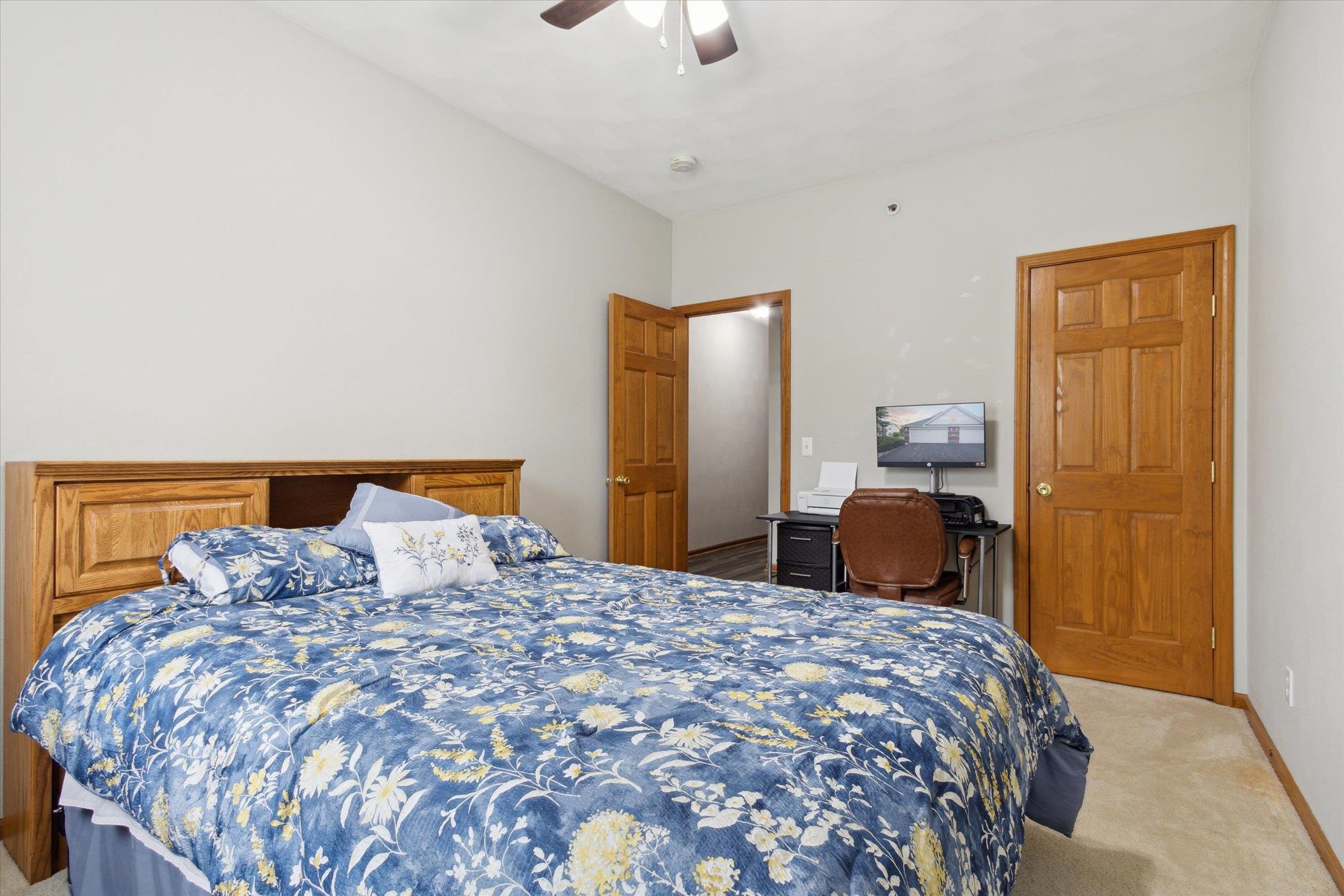 10156 Metalmark Lane, Unit 2 Roscoe, IL 61073 - Photo 24 of 38 a bedroom with a bed and a chandelier