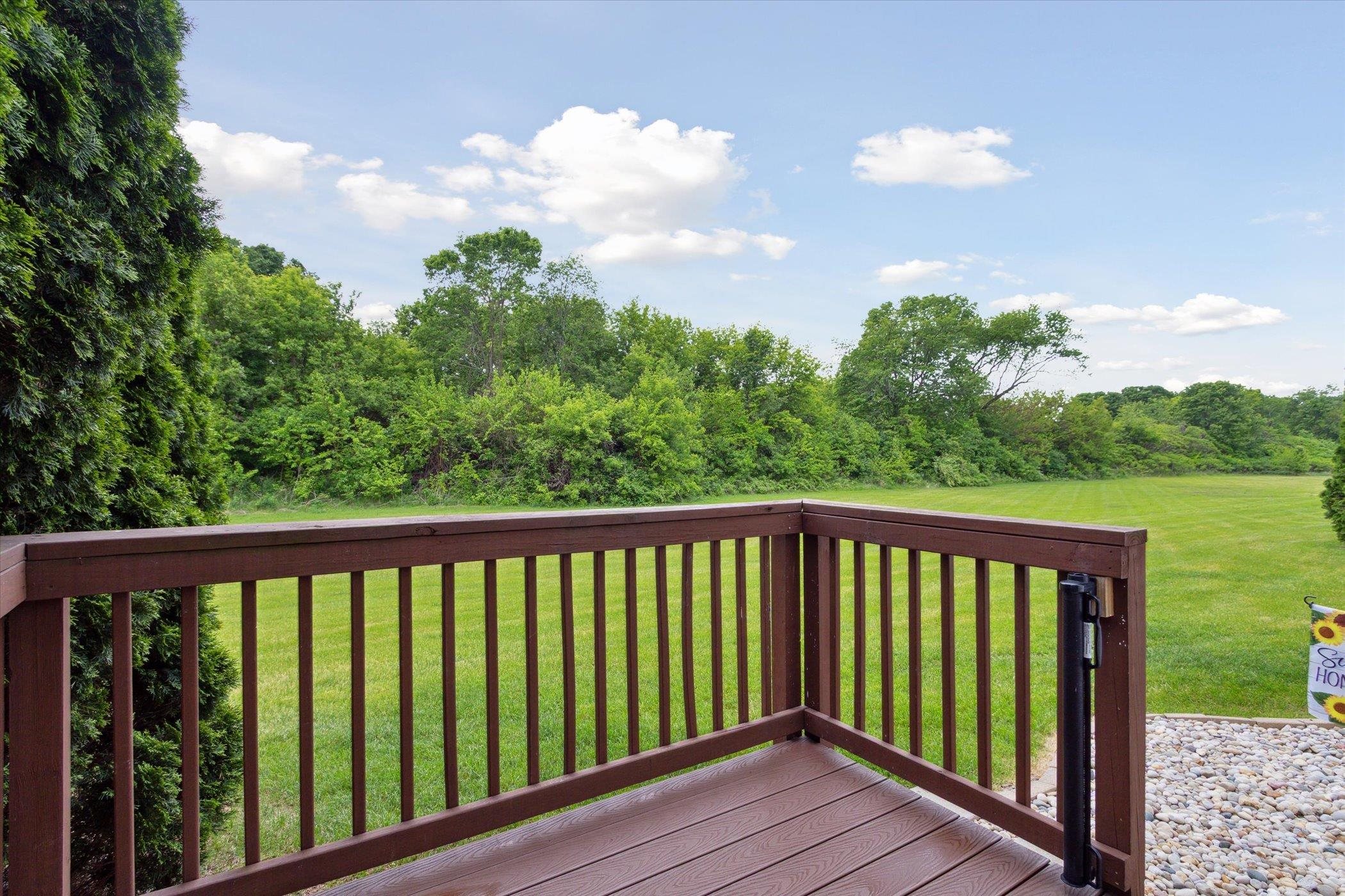 10156 Metalmark Lane, Unit 2 Roscoe, IL 61073 - Photo 34 of 38 a balcony with wooden floor and fence
