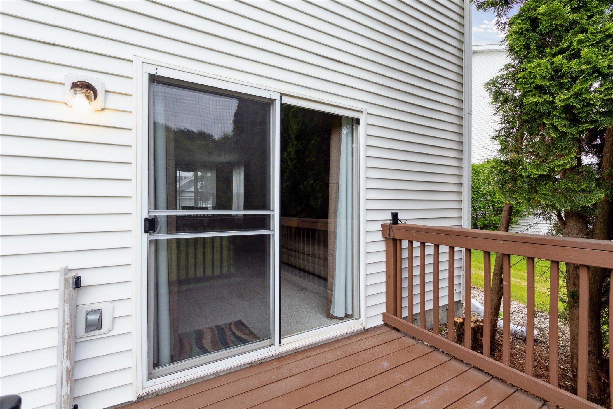 10156 Metalmark Lane, Unit 2 Roscoe, IL 61073 - Photo 35 of 38 a view of a balcony with wooden floor and fence
