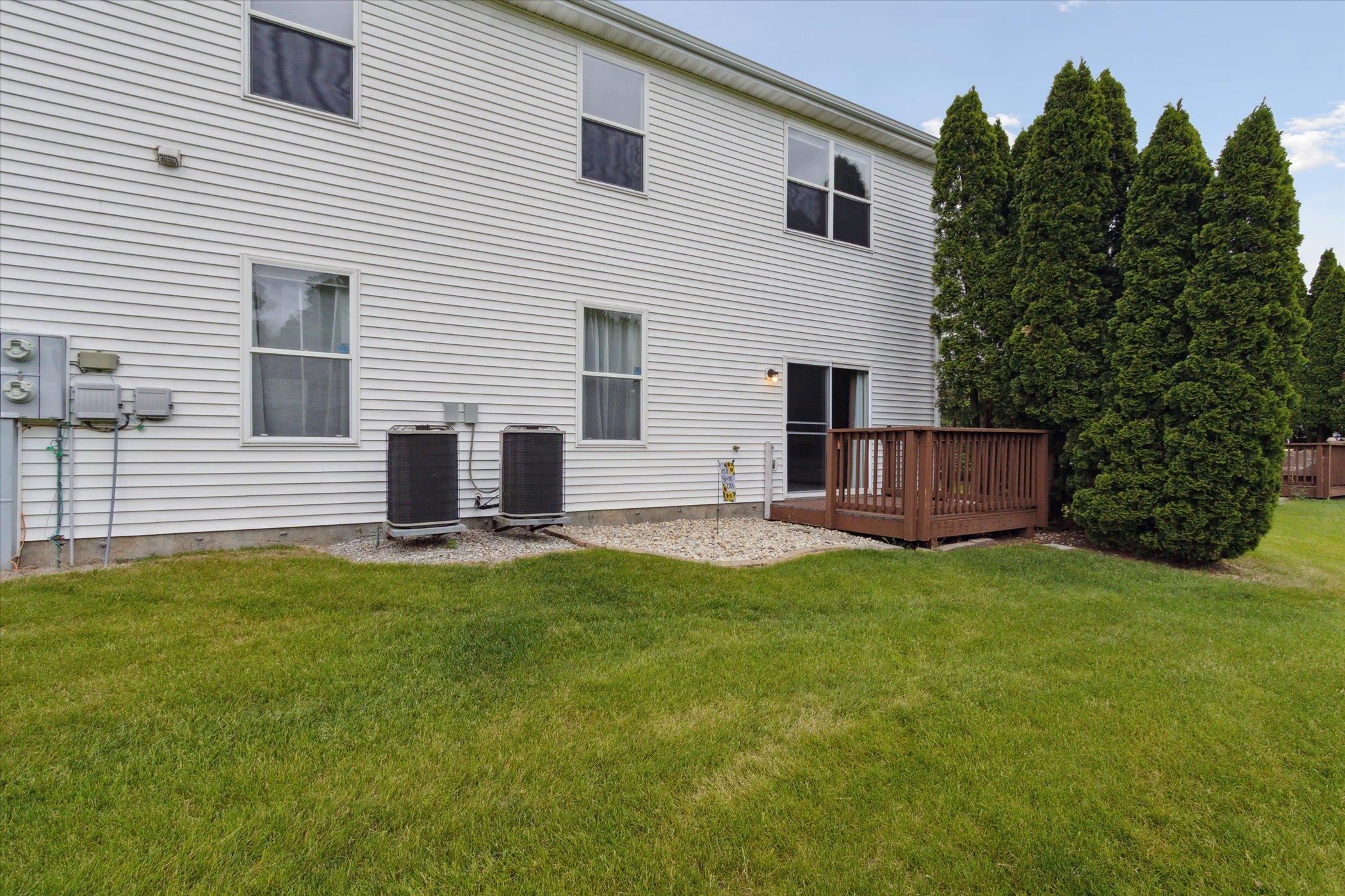 10156 Metalmark Lane, Unit 2 Roscoe, IL 61073 - Photo 36 of 38 a backyard of a house with table and sofas